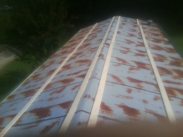 Rusted metal roof panels with new wood purlins before replacement — Storm Damage Roof Repair in Dundas by Roofing Brothers