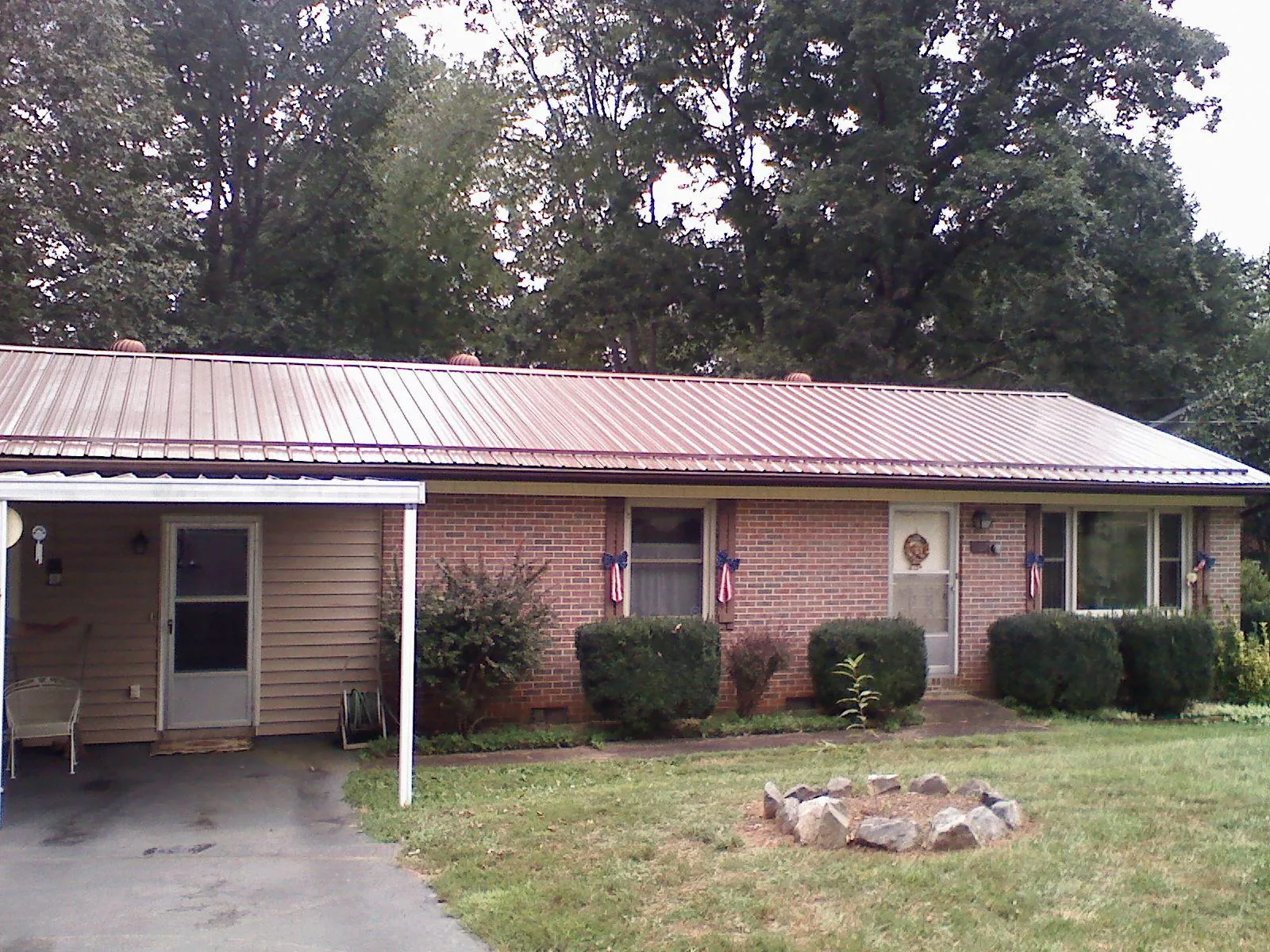 Bronze metal roof and carport on a brick ranch home — Roof Repair work by our crew in Dundas